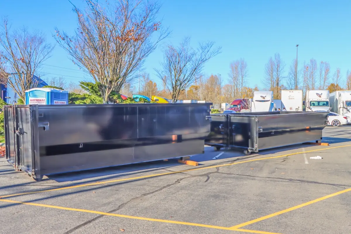 Professional dumpster rental service with roll-off container on residential driveway in Lake of the Pines